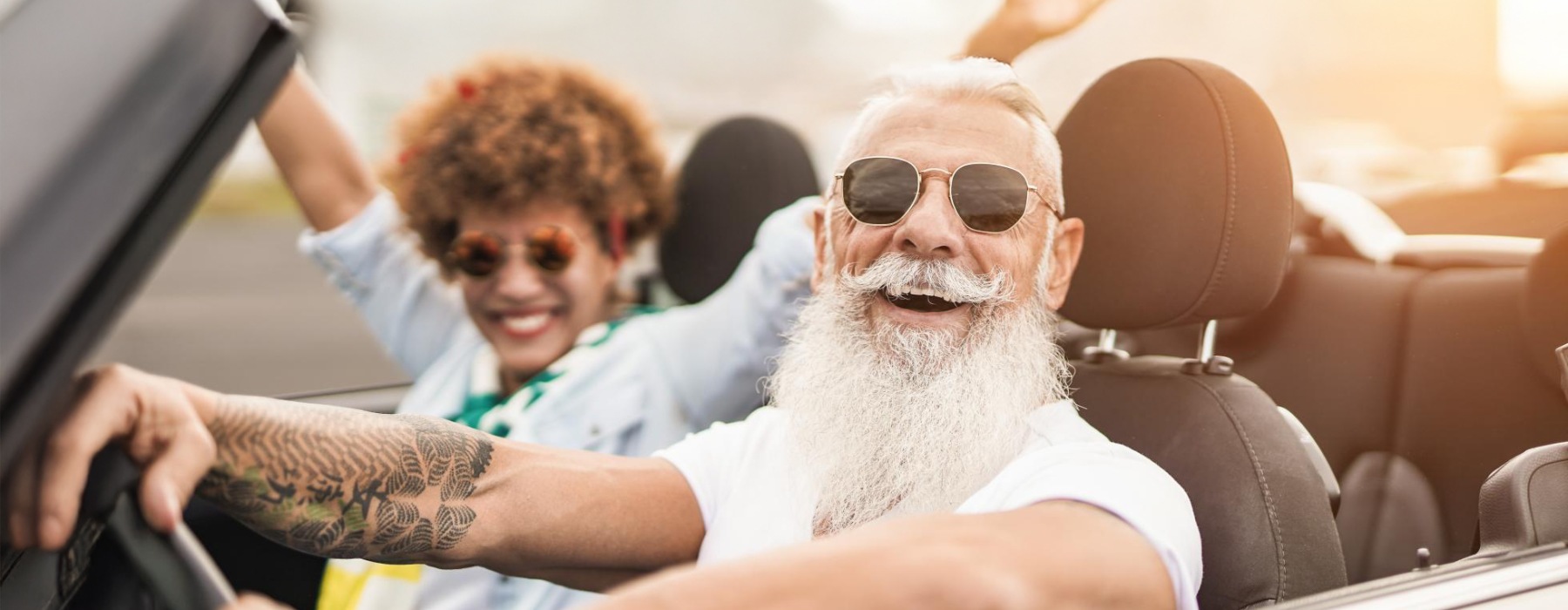 a man and a woman in a car with a large white beard