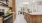 kitchen with stainless steel appliances, large island, ample cabinet storage, custom wood-style cabinetry