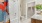 Bathroom with attached oversized closet, shower/tub combination with subway tile surround, quartz vanity with custom cabinetry, medicine cabinet and tile flooring throughout