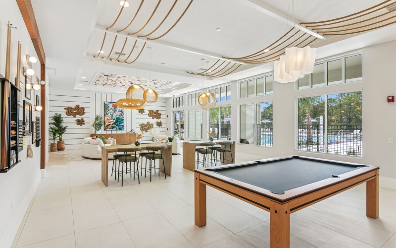 resident clubhouse lounge with pool table, couches and games