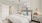 bedroom with attached bathroom and large closet, ceiling fan and light combo, crown molding, large windows 