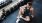 a man sitting down in a fitness center next to some weights